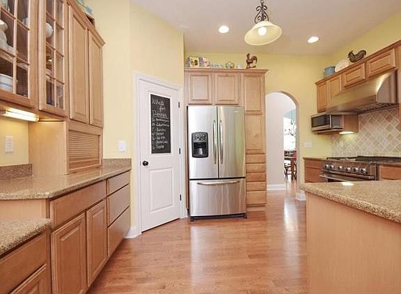 Upscale kitchen with all the grand features for the discerning cook! Huge breakfast bar seats 4 easily. Granite counters and plenty of maple cabinets. Huge walk in pantry. Opens to breakfast room, hearth room and GR.