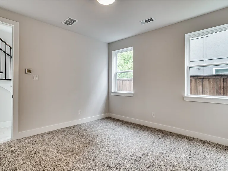 First Floor Guest bedroom has an ensuite bath and would make a great home office. Close to the fenced backyard.