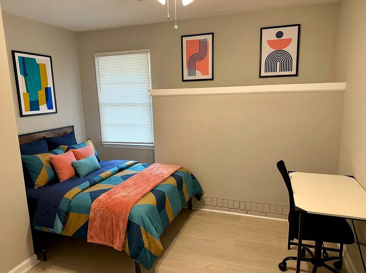 Photo 2 of 3 - Dogwood Dr NW - Lawrenceville, GA Furnished bedroom with a full bed, window with blinds, and a dedicated desk area for work or study. - Dogwood Dr NW