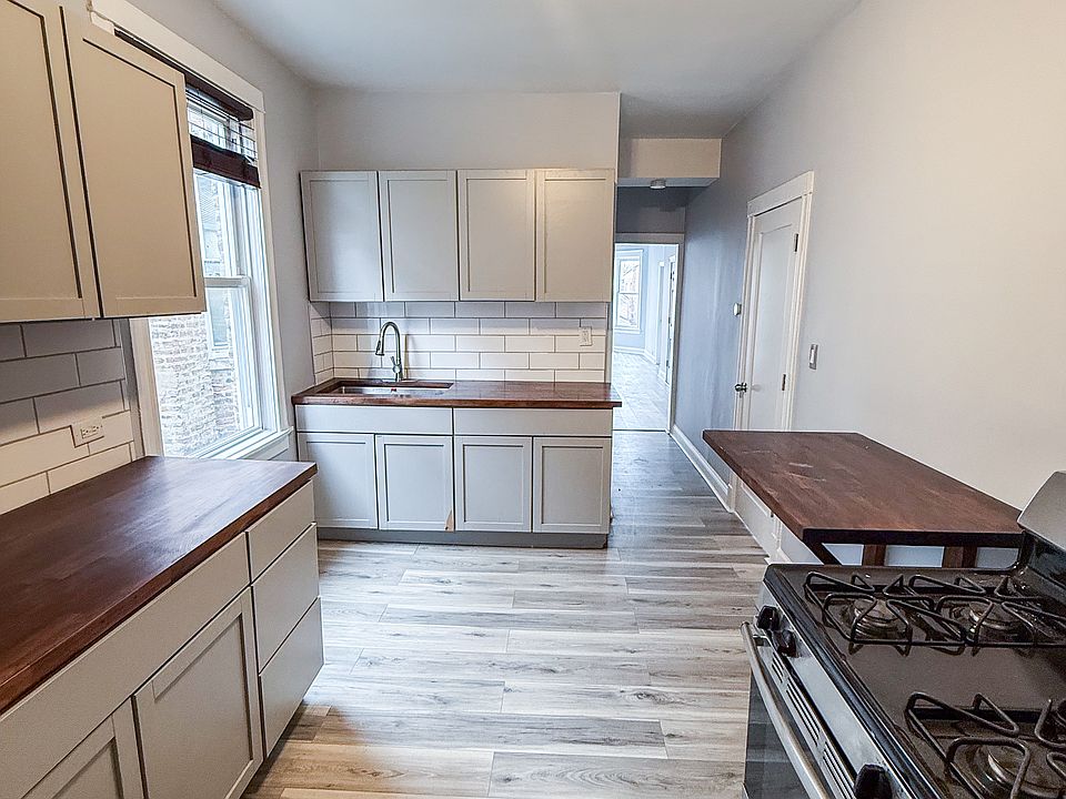 Kitchen with butcher block counter tops and butcher block built in cutting board or breakfast stand.