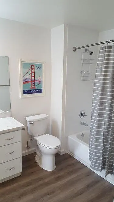 Tiled shower/tub, quartz vanity with extra counter space.