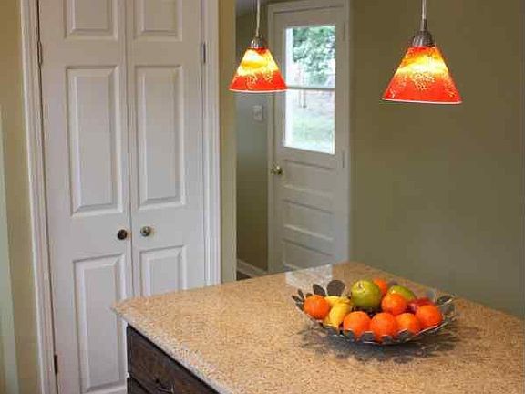 Pantry and kitchen island with pendant lights