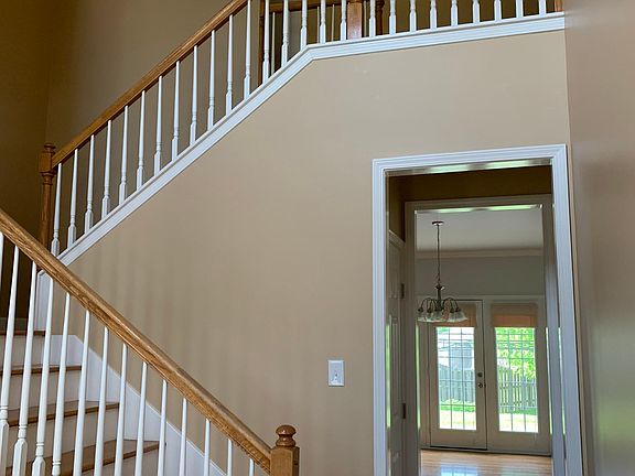 As you walk in, stairs in front of you and back doors that lead to the backyard