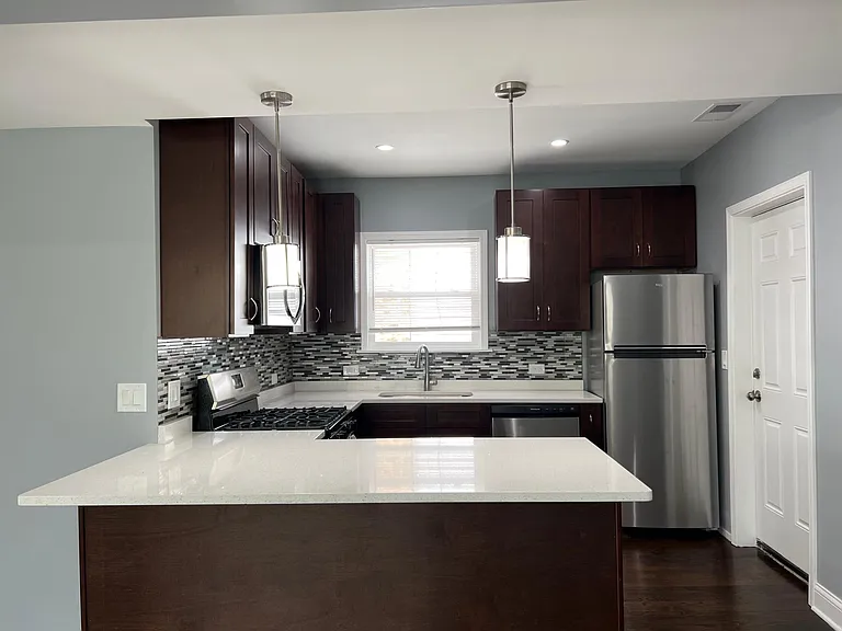 Newly renovated kitchen with 42" express cabinets, brand new stainless steel appliances (including dishwasher), quartz countertops with breakfast bar, and soft-close drawers!