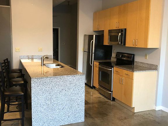 Open plan design with granite counter tops and stainless steel appliances