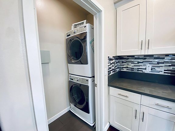 Stacked washer/dryer off kitchen area