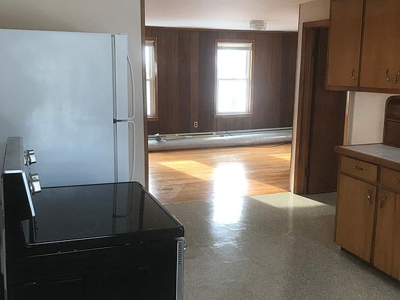 A view entering from your side porch of the open concept kitchen and living room. Plenty of natural lighting all day with all the windows. Room darkening blinds included.