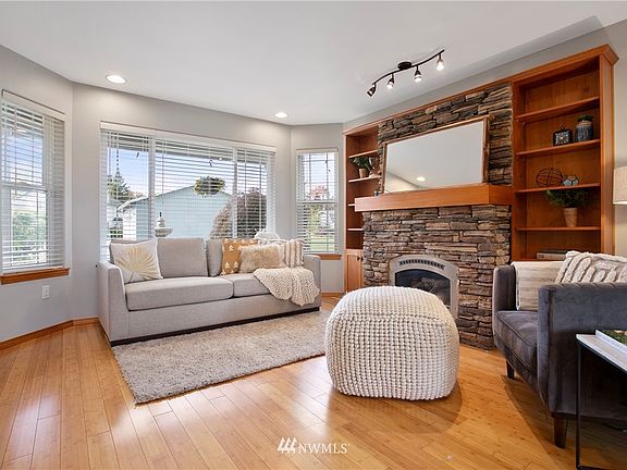 Another view of the living room looking out the large windows onto the front property. 