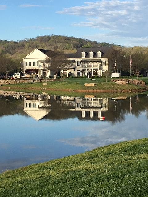 View of the building from greenway trail across the lake.