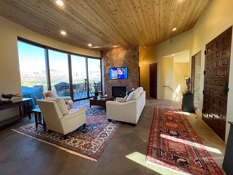 Living Room and Foyer with Staircase to Lower Level and Hall to Master Suite 2