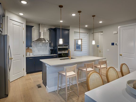 Enjoy your coffee each morning at the kitchen island with overhead pendant lighting.
