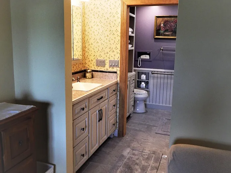 frosted glass pocket door closes to separate the ensuite vanity area from the bathroom area