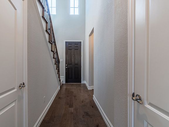 Welcoming entryway with two-story ceilings.