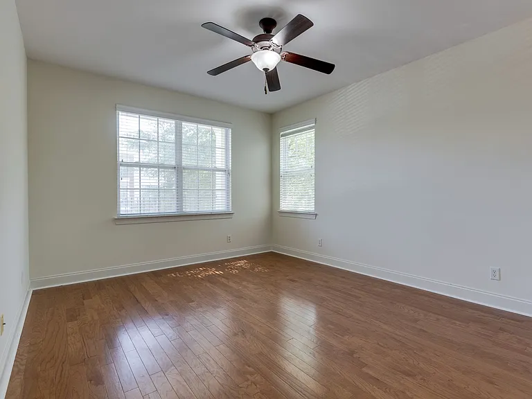 Primary bedroom with 3 windows,
 Private bath, & Walk-in closet