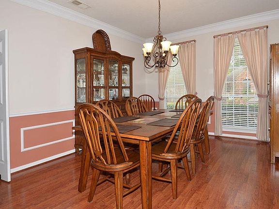  Large dining room with updated lighting and wood floors.