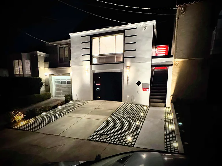 Lit driveway and entrance.
