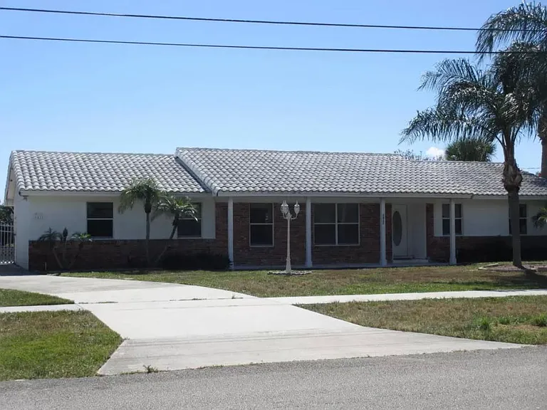 Front of House and Driveway that wraps around side of house