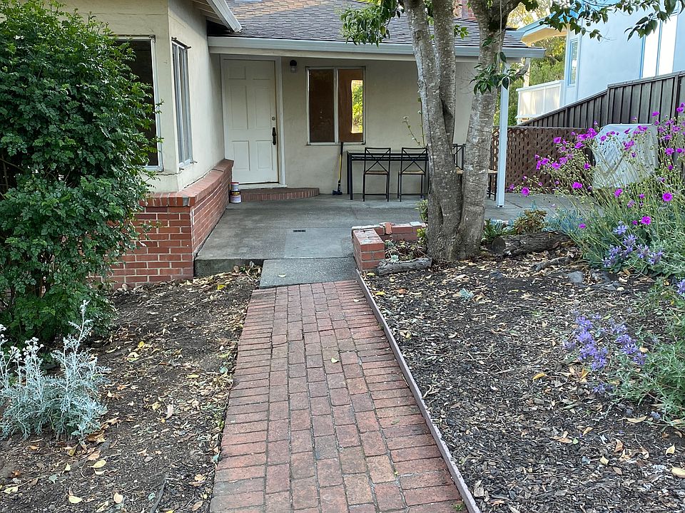 Front yard with garden areas.