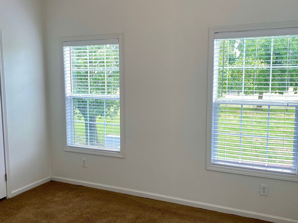 This bedroom offers spaciousness and lots of windows to allow in natural light.