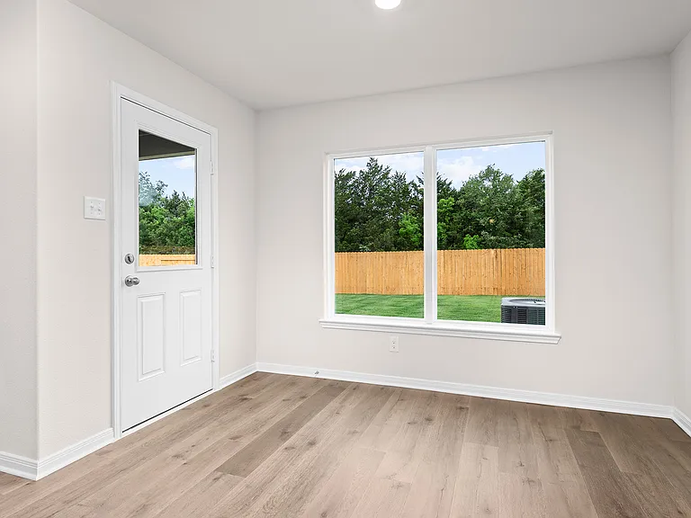 The dining room has a large window to let in natural light.