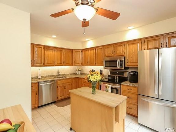 Kitchen has granite counters and stainless steel appliances.