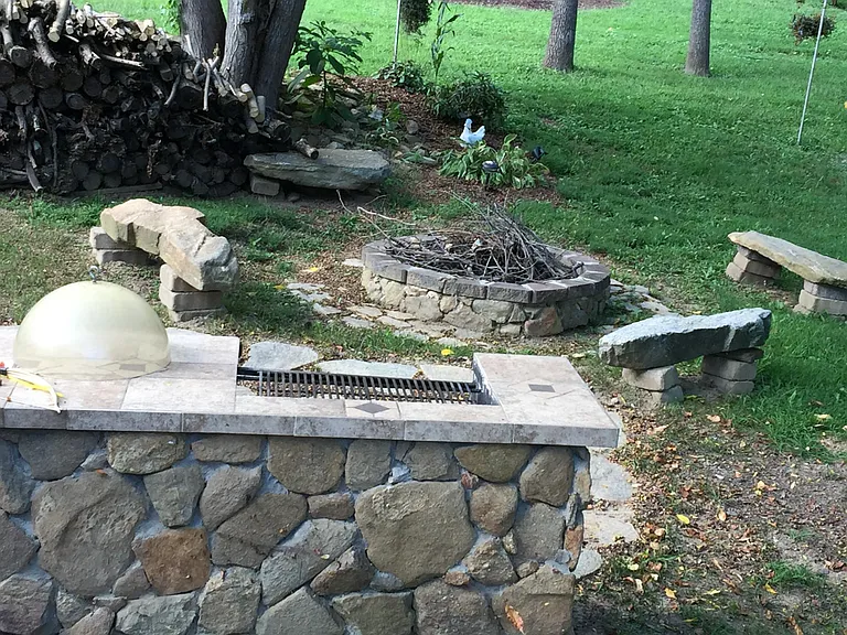 barbecue area and fire-pit area with stone benches