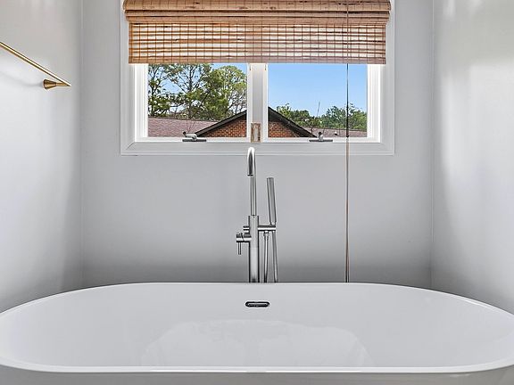 Master bath with double sinks, large soaking tub, shower, linen closet and large walk-in closet.