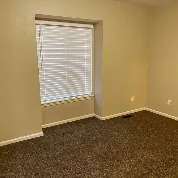 Master bed with new carpet and privacy blind