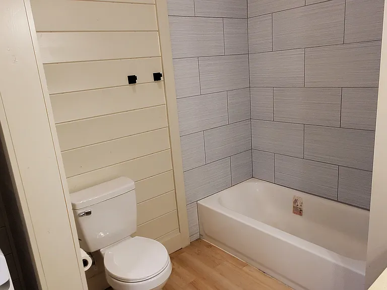 Full bathroom with tub + tiled shower.