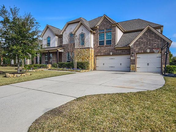 Front elevation features triple wide driveway for extra parking space.
