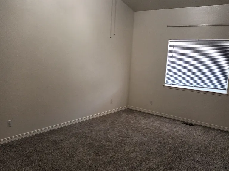 master bedroom with high valuated ceiling