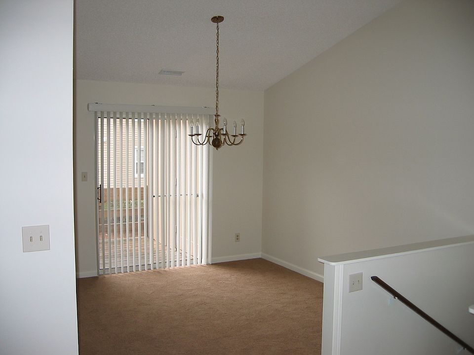 Entry to second floor condo into Dining Room with access to large deck. Notice cathedral ceiling. Eat-in Kitchen and Living Room next to Dining Room.