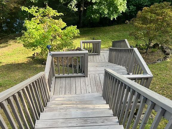 Stairs descending to road and pond
