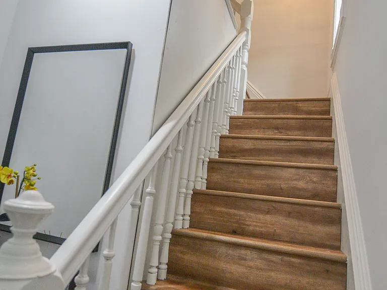 Foyer. Staircase going up to the bedroom, bathroom, kitchen, and living room