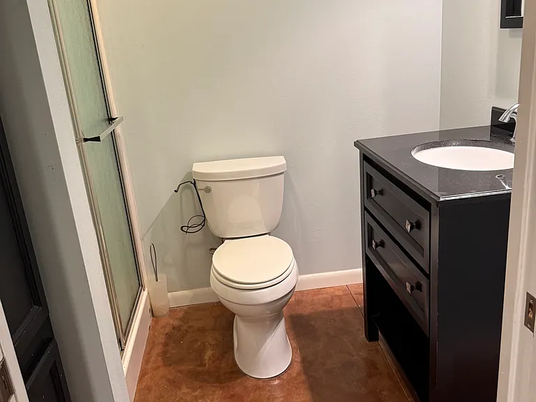 Ensuite bathroom off larger bedroom with shower.