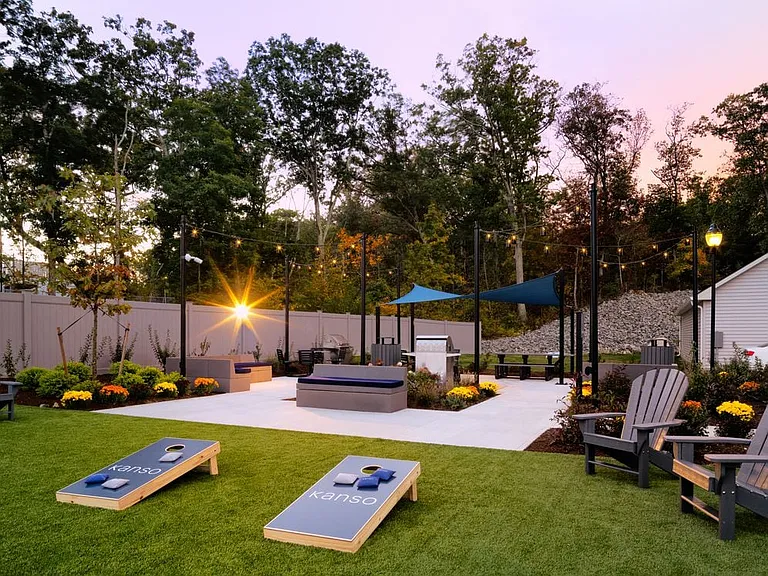 Courtyard with grilling stations, cornhole, and lounge seating