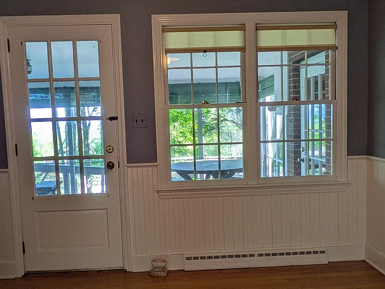 Dining room back door to screened porch. Large sunny windows throughout