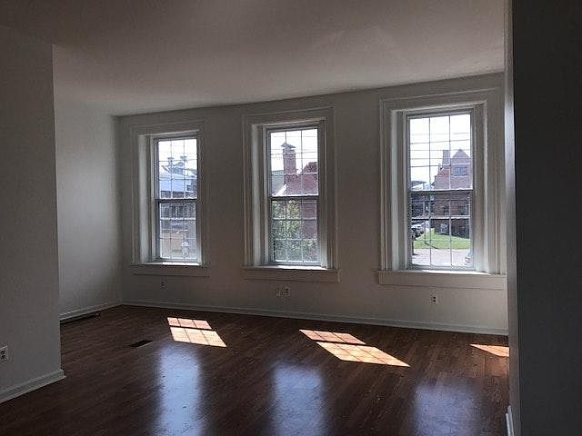 Bright living room with 8 foot high windows and 12 foot ceil