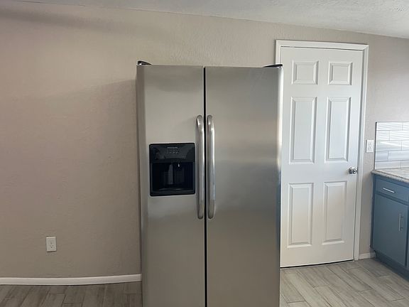 Side by side refrigerator. 

The adjacent door way leads into the laundry room hook up's, storage and a separate exterior door to the carport.