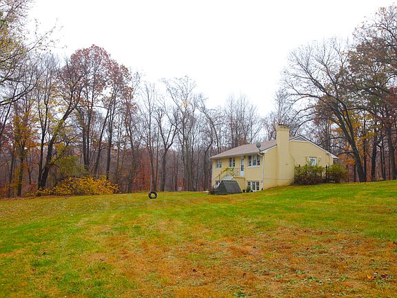 Large yard behind church, surrounded by woods