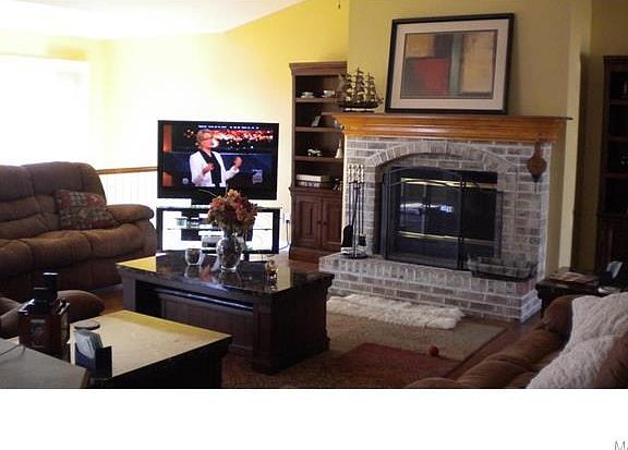 Living offers stone fireplace and hardwood floors with an open floor plan.