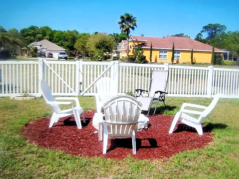 large fenced back yard overlooking the pond and sunset