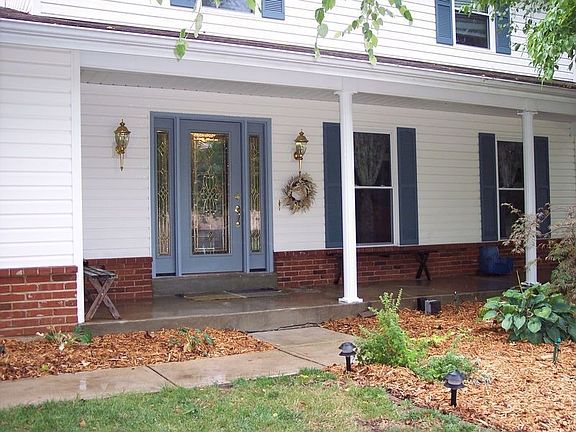 Front porch with leaded glass front door and side lights.