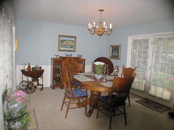 Sun drenched formal dining room with double sets of french doors