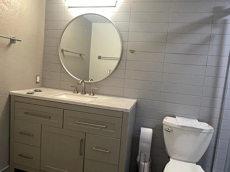 Remodeled bathroom with sliding tempered glass walk in shower.