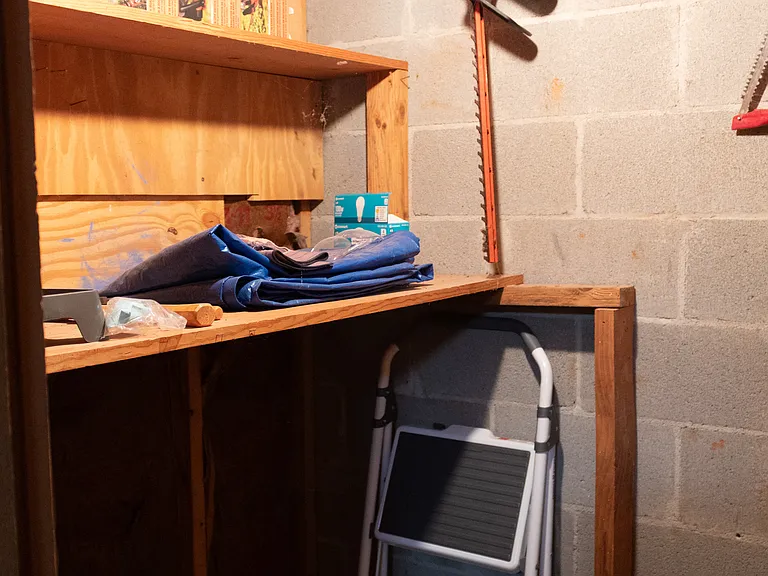 To the left of the bathroom is a storage or equipment room.