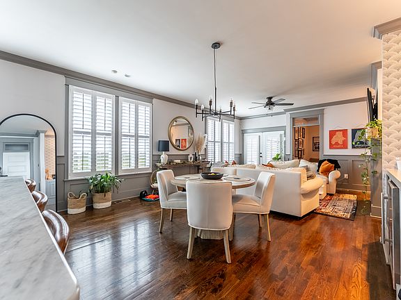 Living, dining and living room, plus office, bathroom, laundry room, bar area, and pantry level