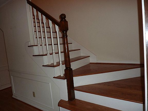 Solid oak stairs lead off the entry hall