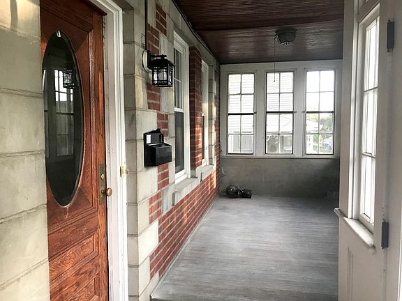 View of closed front porch and front door of the 1st floor apartment.