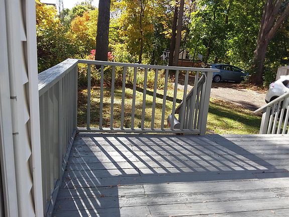 Looking out from the deck to the driveway area and yard.